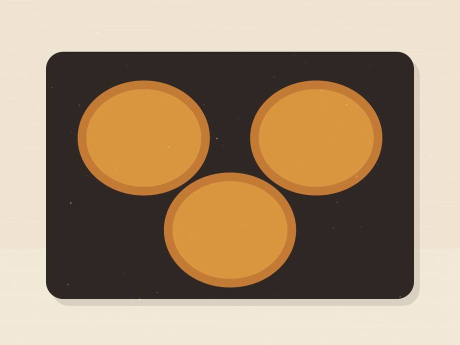 Illustrated griddle with three flipped pancakes, deep golden brown on top