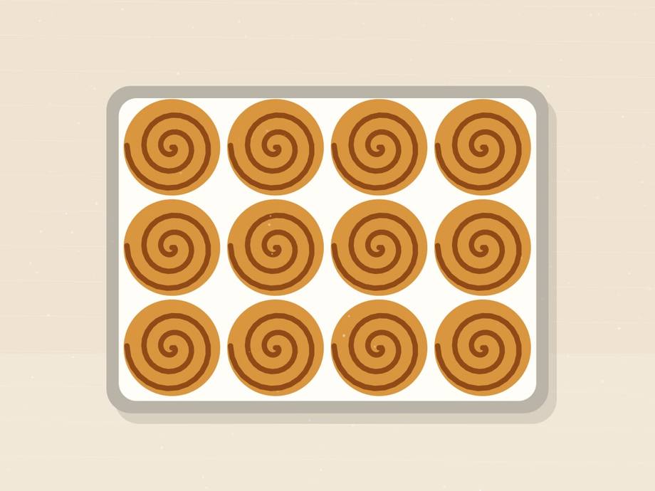 Illustrated baking pan holding twelve unbaked spiral rolls in rows