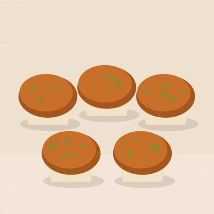 Illustrated orange pumpkin muffins in cream liners topped with green pumpkin seeds