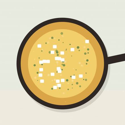 Illustrated skillet frittata flecked with spinach, cubes of white feta and herbs